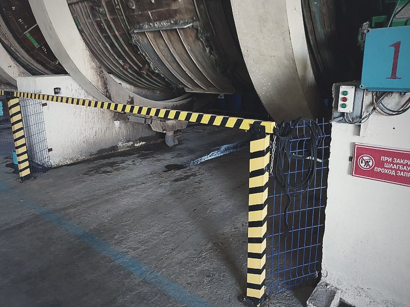 Interlocked barrier across a tanning drum bay, with floor markings